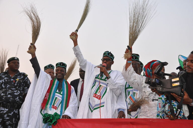 General_Buhari_holding_a_broom_at_a_campign_rally-768x510
